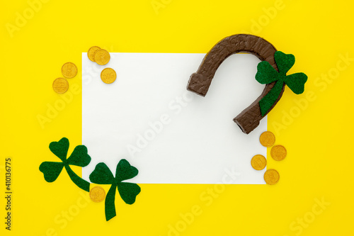 Composition for St. Patrick's Day. Decorating paper with green clover or shamrocks, gold coins and horseshoe