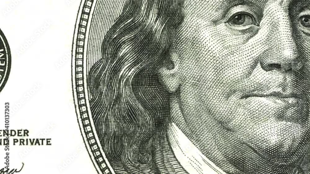 Camera scanning quickly across a United States 100 dollar bill - seamless looping.