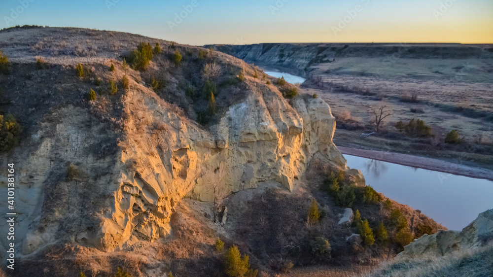Fototapeta premium View of the winding river from the mountain in the evening at sunset. North Dakota