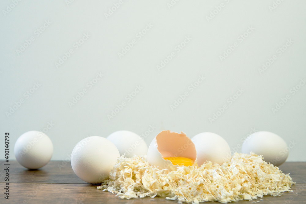 Soft boiled egg on with white eggs and on a white background. Easter breakfast concept. Copy space. Soft focus.