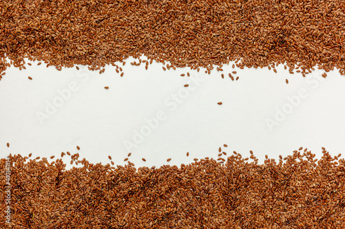 brown Flax seeds scattered on a white table