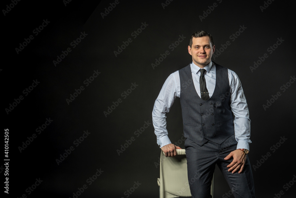 in a three-piece suit on a chair Young male three piece suit business model, young white guy. Serious formal, success lonely background black bodybuilder in a three-piece suit on a chair Young male three piece suit business model, young white guy. Serious formal, success lonely background black bodybuilder
