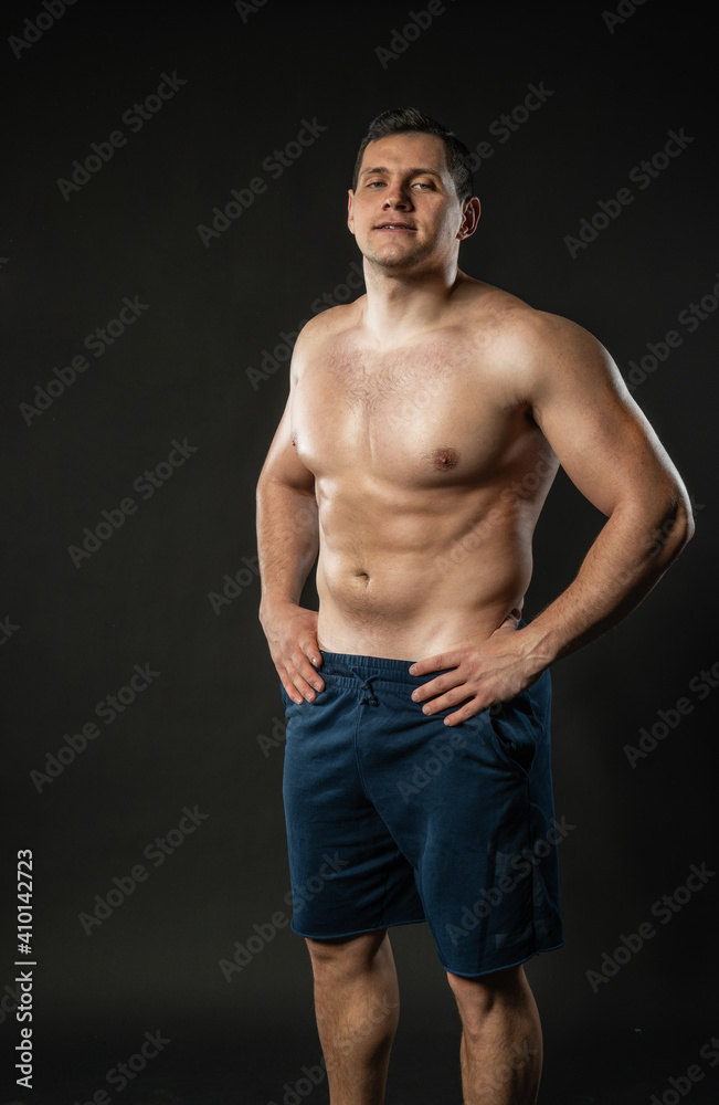 Hands on the belt of a man's bare torso is sexy Young male man, young happiness boy, trendy cool background black bodybuilder Hands on the belt of a man's bare torso is sexy Young male man, young happiness boy, trendy cool background black bodybuilder