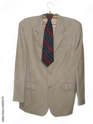  Gray jacket with dark tie on wooden hanger with metal hook isolated on white background
