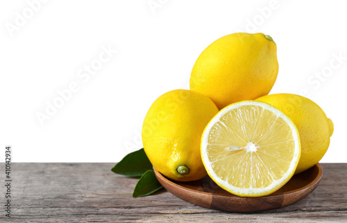 Fresh lemon and sliced on the wooden table and the white background with copy space for your text.