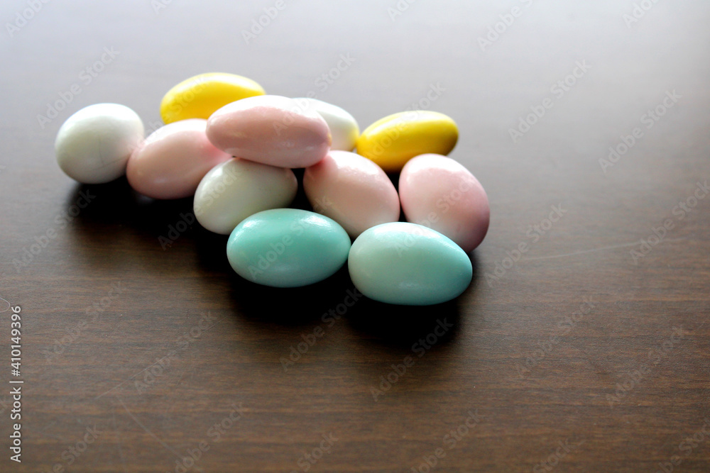 Mix of almond candies on wooden background, top view Mix of almond candies on wooden background, top view