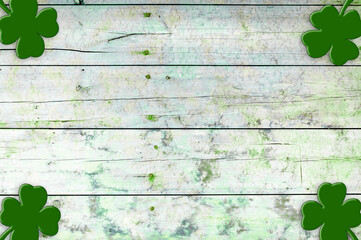 St Patricks day background. Shamrocks over a light green wood background