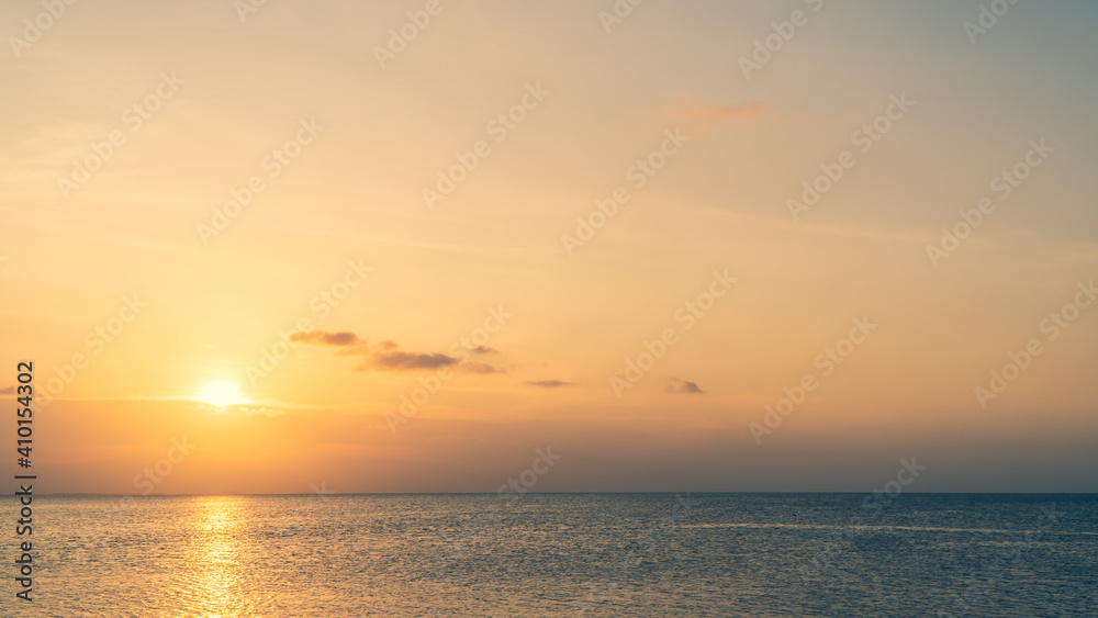 Sunset sky over sea in the evening with colorful sunlight on dusk sky.