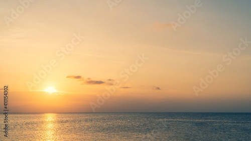 Sunset sky over sea in the evening with colorful sunlight on dusk sky. © Nature Peaceful 