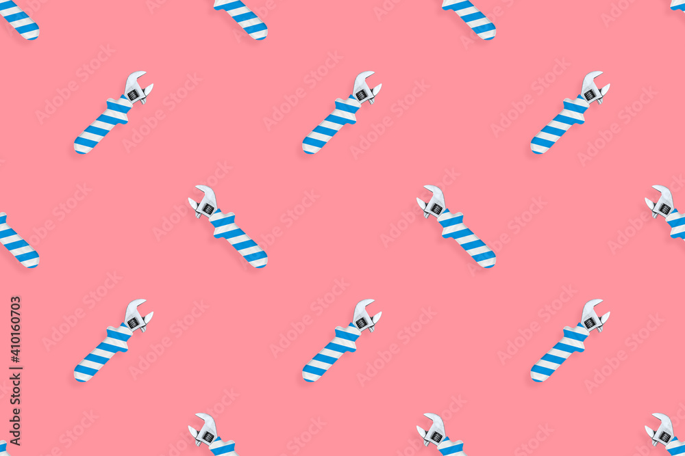 Fototapeta premium Adjustable wrench seamless pattern. Background made of a metal adjustable wrench with a rubber striped handle. 