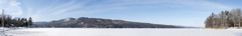Panoramic view of a winter scene of a lake and mountains in winter Panoramic view of a winter scene of a lake and mountains in winter