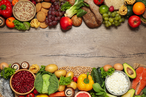 Different products on wooden table  top view with space for text. Healthy food and balanced diet