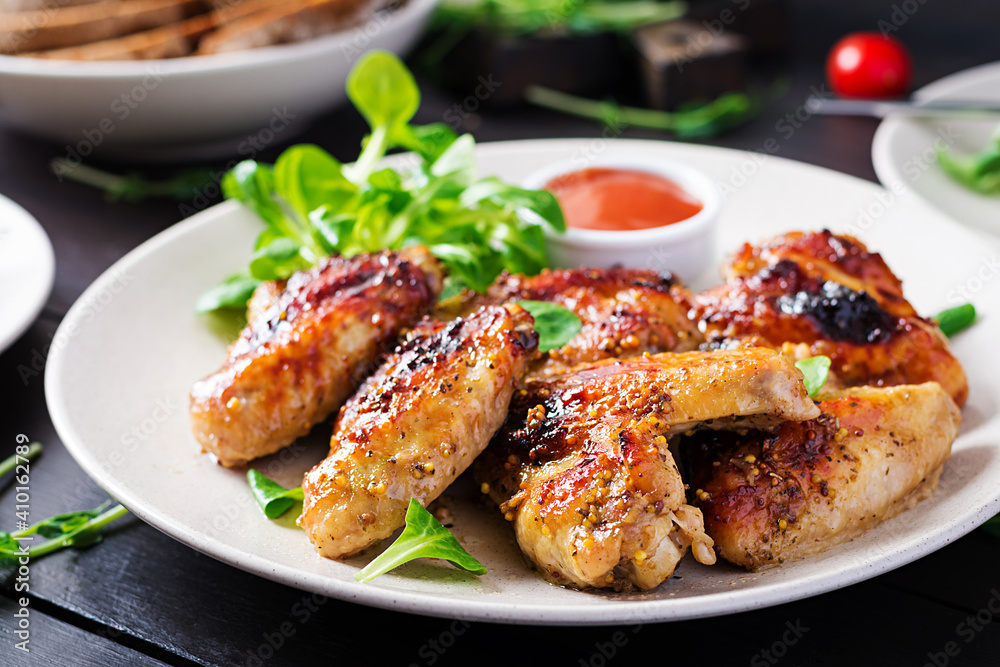 Grilled chicken wings. Baked chicken wings on wooden table.