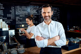 Successful restaurant manager small business owner standing in cafe