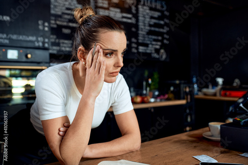 Photos Frustrated small business owner in closed cafe