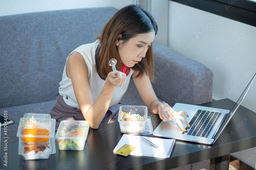 Young attractive asian female hungry eat doughnut take away snack food with full mouth look at computer notebook at home in busy work from home multitask unhealthy meal lifestyle concept.
Young attractive asian female hungry eat doughnut take away snack food with full mouth look at computer notebook at home in busy work from home multitask unhealthy meal lifestyle concept.