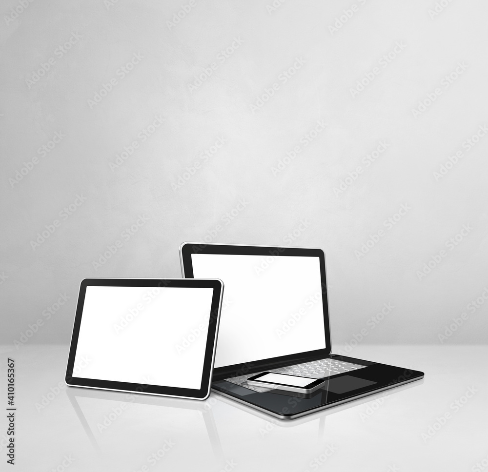 Laptop, mobile phone and digital tablet pc on white concrete office desk Laptop, mobile phone and digital tablet pc on white concrete office desk
