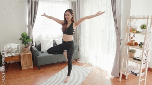 Young Asian women lovey with yoga exercise and stretching in the living room