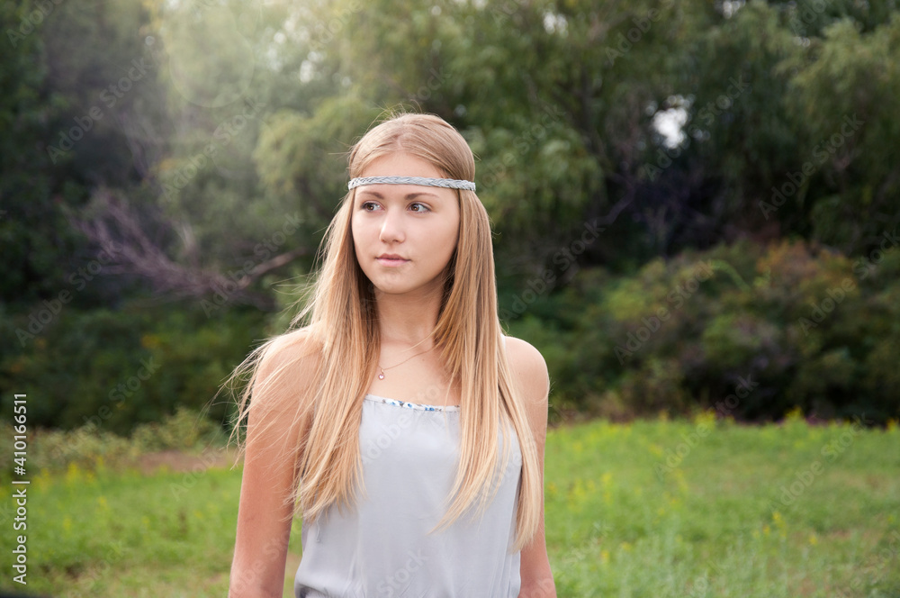 beautiful blonde in a gray dress on a walk in the park beautiful blonde in a gray dress on a walk in the park