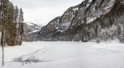 Panoramic view of frozen lake and snow covered mountains