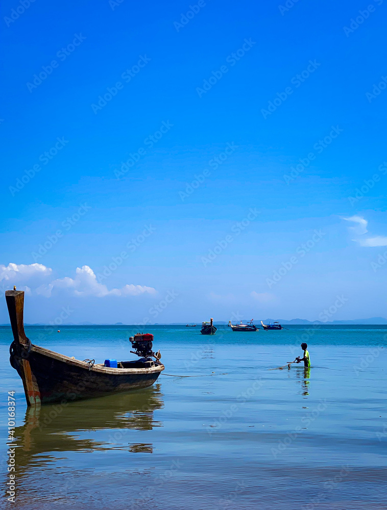 Boat on the sea / young fisherman.
