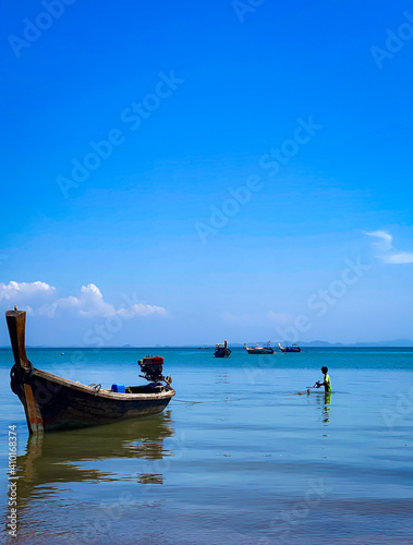 Boat on the sea / young fisherman. © Carl