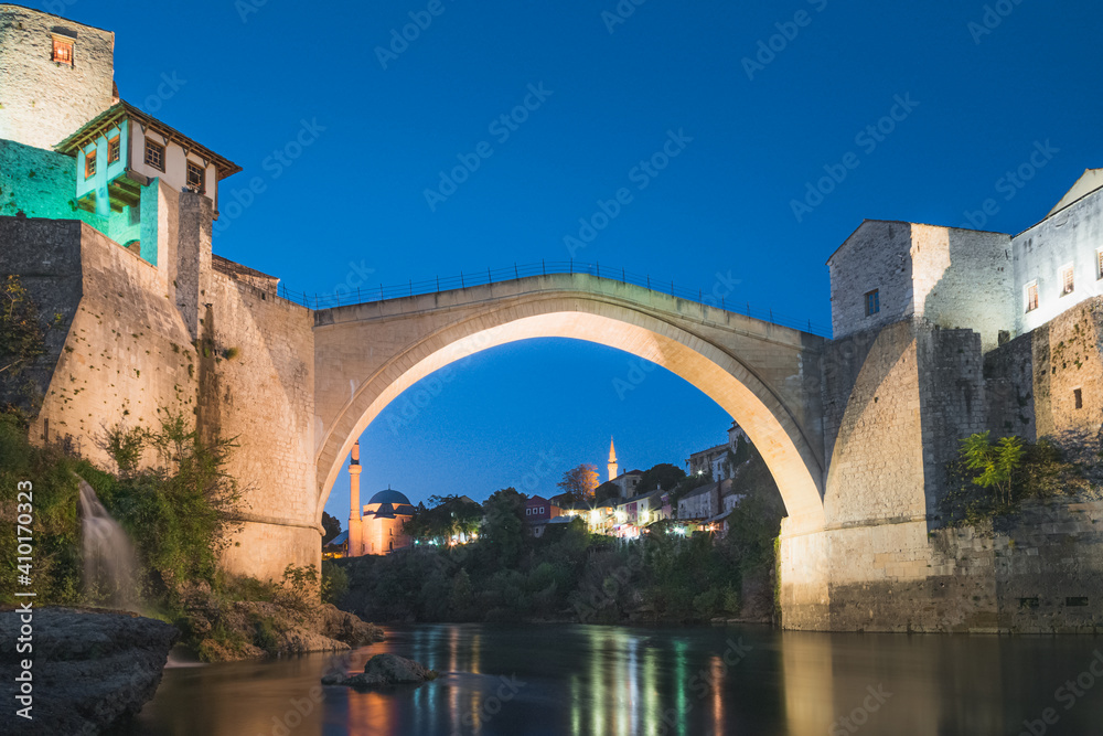 Evening, blue hour view of the iconic Stari Most bridge, Neretva River and old town of Mostar, Bosnia and Herzegovina.