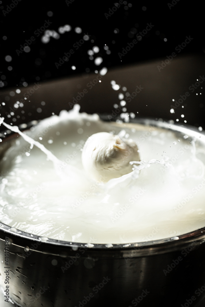 Italian hard cheese silano or caciocavallo in cheesemaker hands. The homemade cheese maker produces caciocavallo. Pasta filata, Traditional Italian mozzarella Italian hard cheese silano or caciocavallo in cheesemaker hands. The homemade cheese maker produces caciocavallo. Pasta filata, Traditional Italian mozzarella