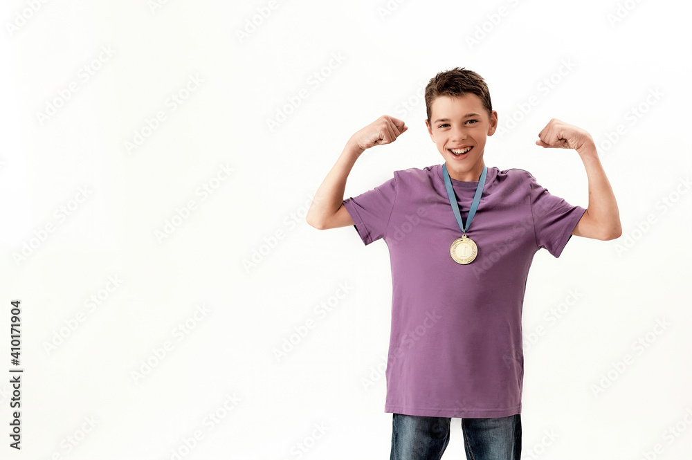 Happy teenaged disabled boy with cerebral palsy wearing gold medal, smiling at camera, raising clenched fists, feeling strong, standing isolated over white background Happy teenaged disabled boy with cerebral palsy wearing gold medal, smiling at camera, raising clenched fists, feeling strong, standing isolated over white background