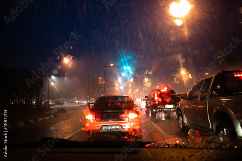 Cars driving through rainy at night