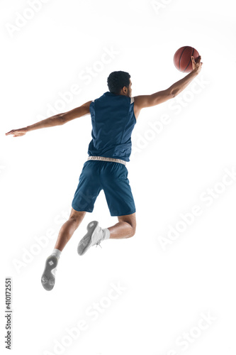 High flight. Young arabian muscular basketball player in action, motion isolated on white background. Concept of sport, movement, energy and dynamic, healthy lifestyle. Training, practicing. © master1305