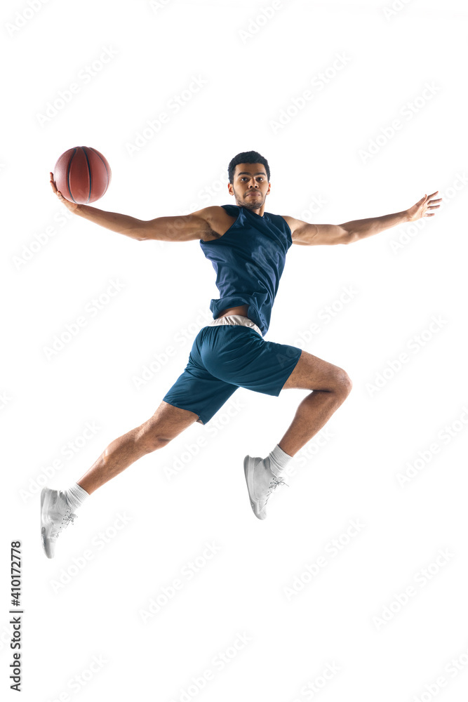 High flight. Young arabian muscular basketball player in action, motion isolated on white background. Concept of sport, movement, energy and dynamic, healthy lifestyle. Training, practicing.
