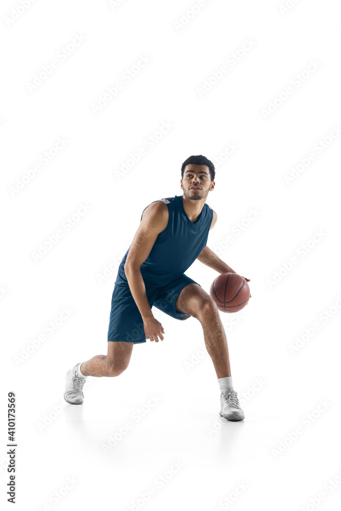 Leader. Young arabian muscular basketball player in action, motion isolated on white background. Concept of sport, movement, energy and dynamic, healthy lifestyle. Training, practicing.