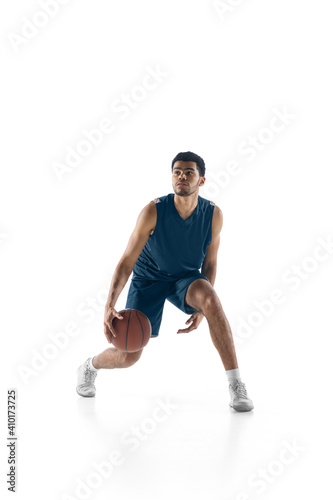 Leader. Young arabian muscular basketball player in action, motion isolated on white background. Concept of sport, movement, energy and dynamic, healthy lifestyle. Training, practicing. © master1305