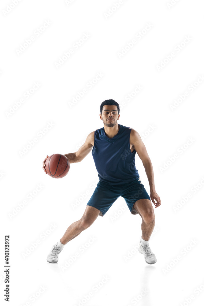 Competitive. Young arabian muscular basketball player in action, motion isolated on white background. Concept of sport, movement, energy and dynamic, healthy lifestyle. Training, practicing.