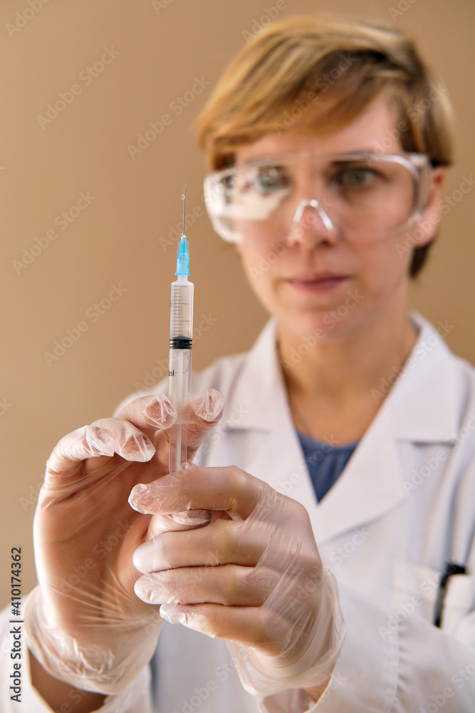 Female nurse doctor wear white coat, protective gloves and glasses