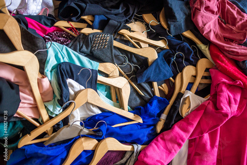 Принти на полотні Lots of clothes on hangers piled in a pile