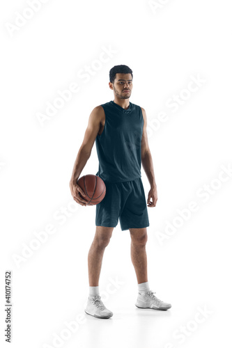 Achievements. Young arabian muscular basketball player posing confident isolated on white background. Concept of sport, movement, energy and dynamic, healthy lifestyle. Training, practicing.