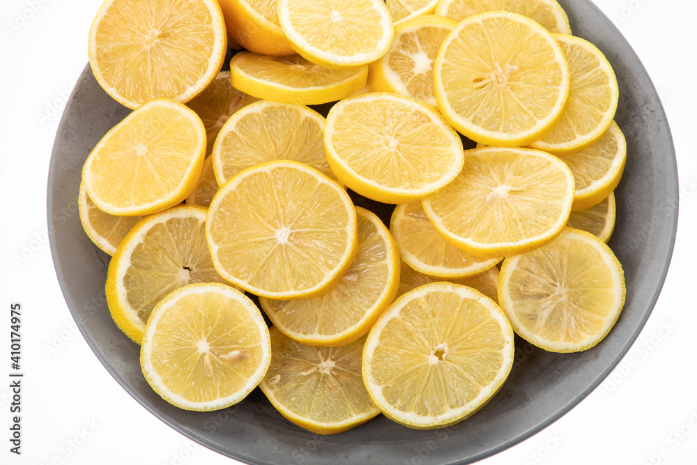 lemon slices on grey plate with white background lemon slices on grey plate with white background