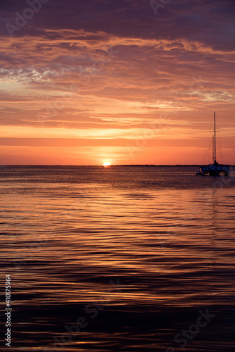 Sea boat on water. Sailboats at sunset. Ocean yacht sailing along water. © Volodymyr