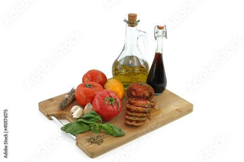 oil and tomatoes isolated on white background