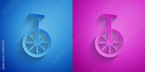 Paper cut Unicycle or one wheel bicycle icon isolated on blue and purple background. Monowheel bicycle. Paper art style. Vector.