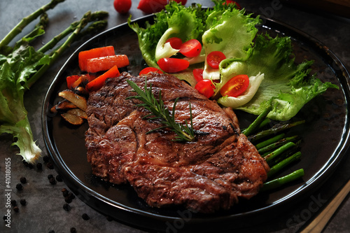 Beef Steaks in a Hot Plate on a Dark Floor