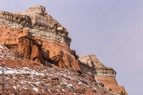 Changing colors of geological formations on mountain with patches of snow in rural New Mexico