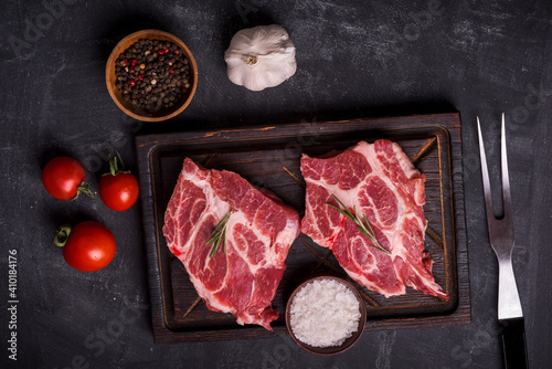 Barbecue Rib Eye Steak on wooden cutting board at kitchen table