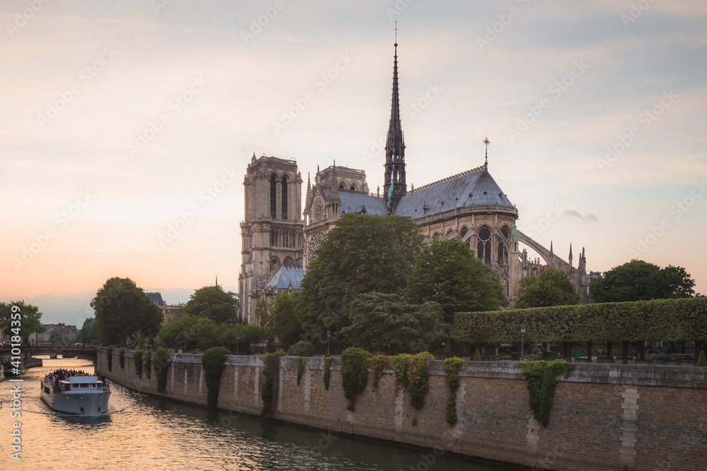 A backside view of the famous Notre Dame Cathedral in Ile de la Cite in Paris, France at sunset