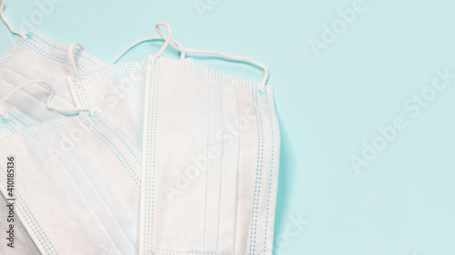 Banner with white medical masks on the blue background. Top view, copy space