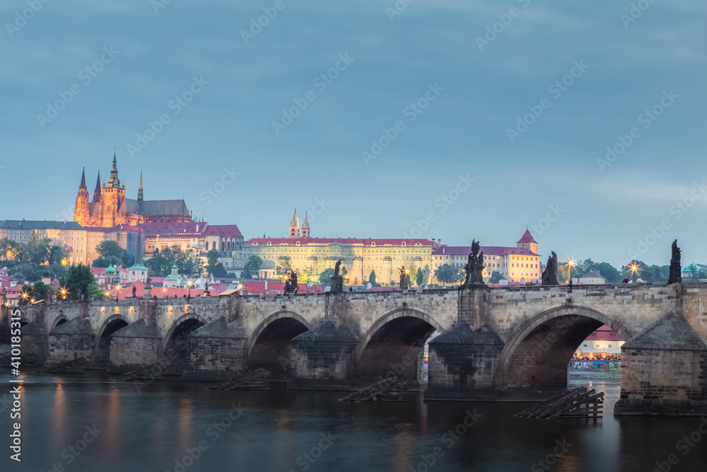 Evening view of Prague, Czech Republic with the Vltava River, Charles Bridge, St. Vitus Cathedral and Prague Castle.