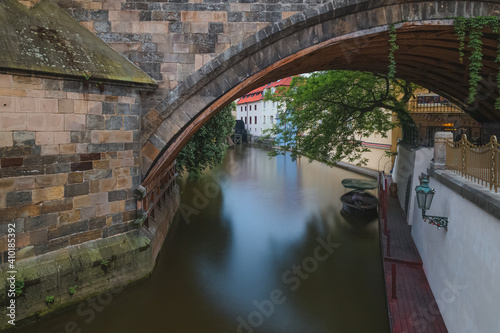 A view underneath one of the arches of Charles Bridge (Karlovy Most) with the Vltava River in Prague, Czech Reoublic.