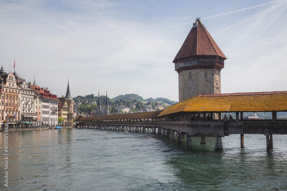 The famous pedestrian Chapel Bridge (Kapellbrcke) over the Reuss River in Lucerne, Switzerland on a bright sunny day